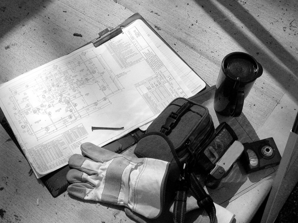 Black and White Shot of construction plans and tools